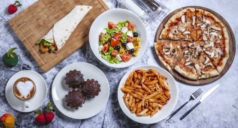A variety of delicious foods including pizza, pasta, salad, coffee, and desserts.